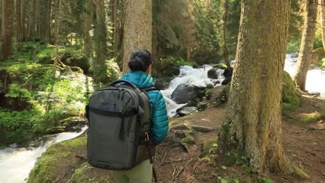 hiking woman walk with a hiking backpack in spring green forest