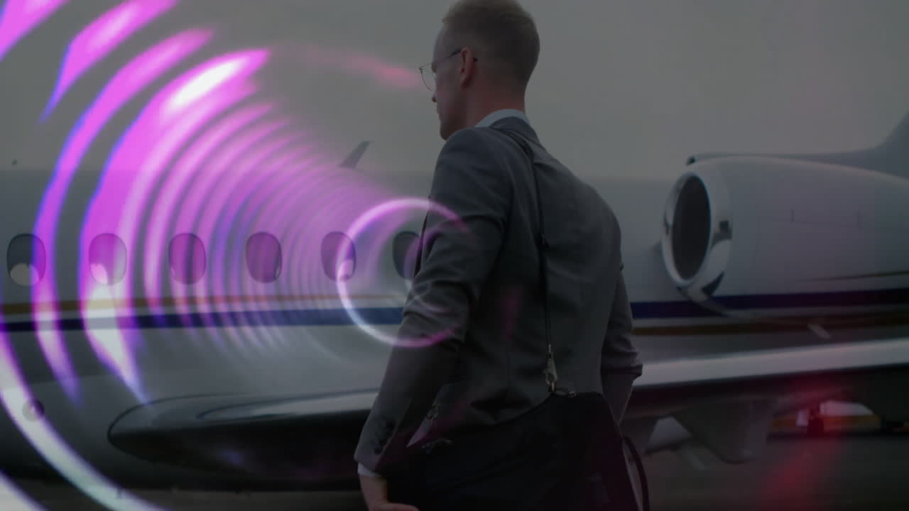 Businessman walking near private jet with colorful circular animation overlay