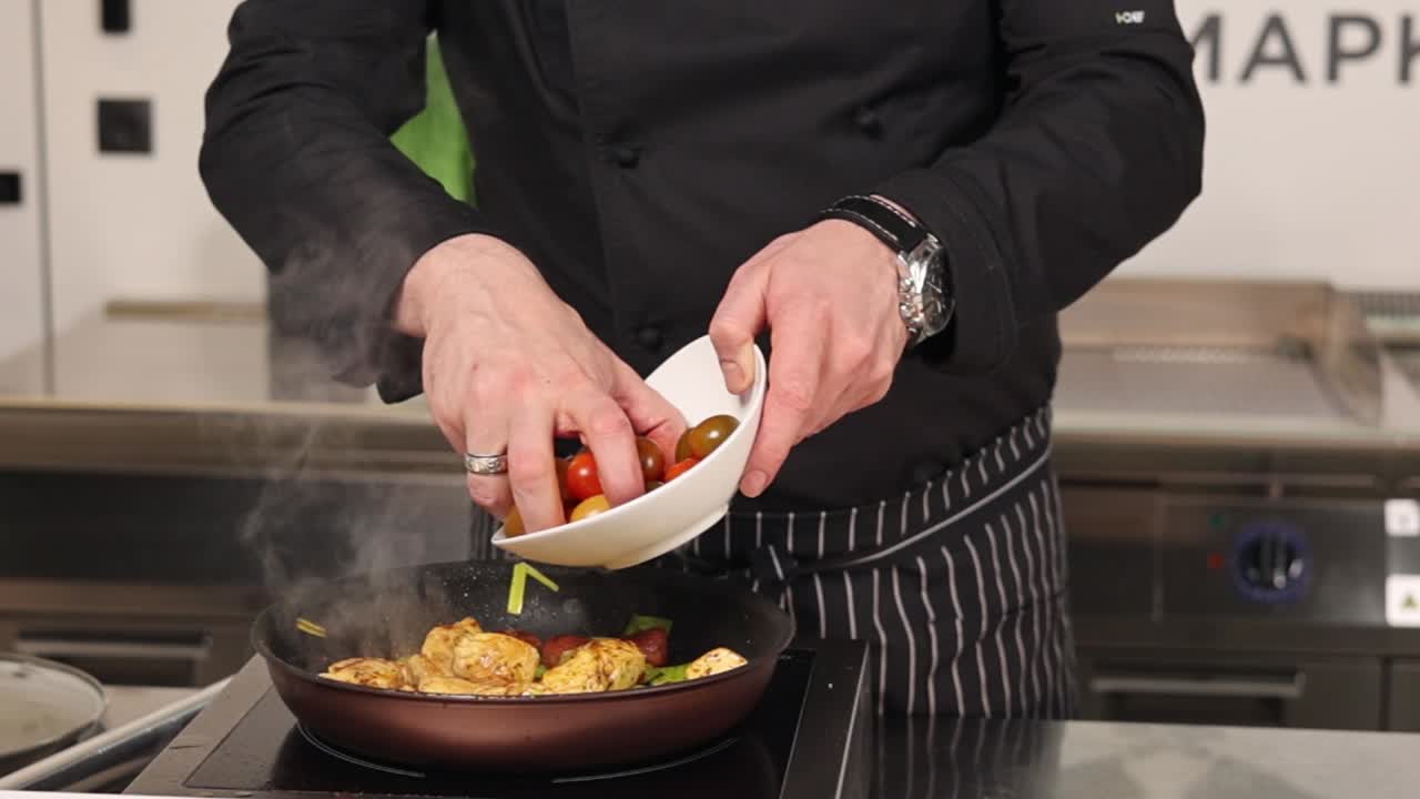 Chef preparing a Chicken dish with tomatoes