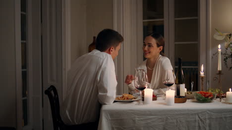 Positive-lovers-talking-at-candles-table-room-closeup.-Laughing-pair-having-fun