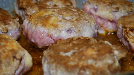 steady close up shot of cooking cutlet style cooked food