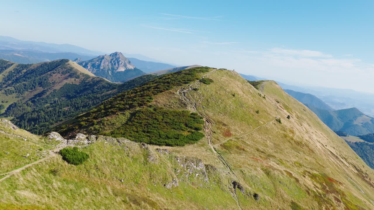 Breathtaking drone footage over Chleb peak in the Malá Fatra mountains, Slovakia, showing scenic ridges, hiking trails, and panoramic views of untouched nature under a clear blue sky