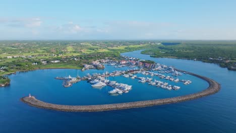 drone wide shot of marina and green scenic landscape of dominican republic in background