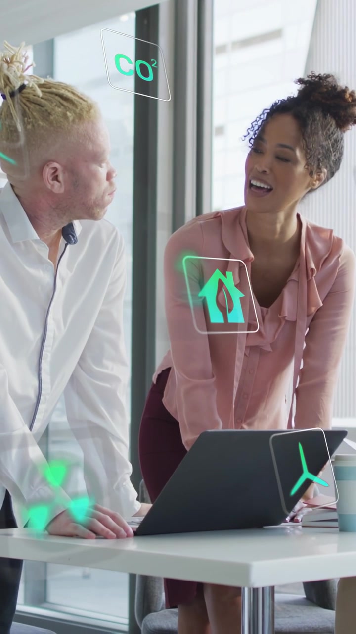 Vertical video: Woman tapping laptop and launching AR energy icons between them, closing pitch