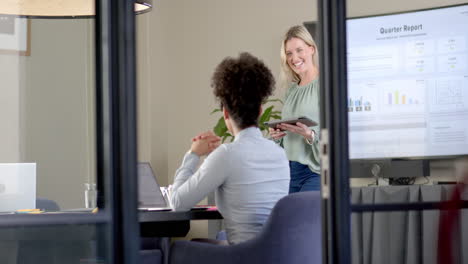 Diverse-business-people-using-laptops-at-conference-table-with-copy-space