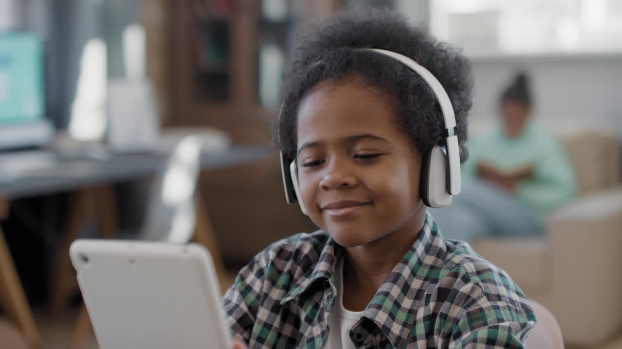 Afro Boy Enjoying Music In Headphones