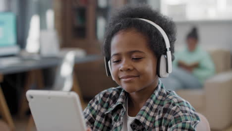 Afro Boy Enjoying Music In Headphones