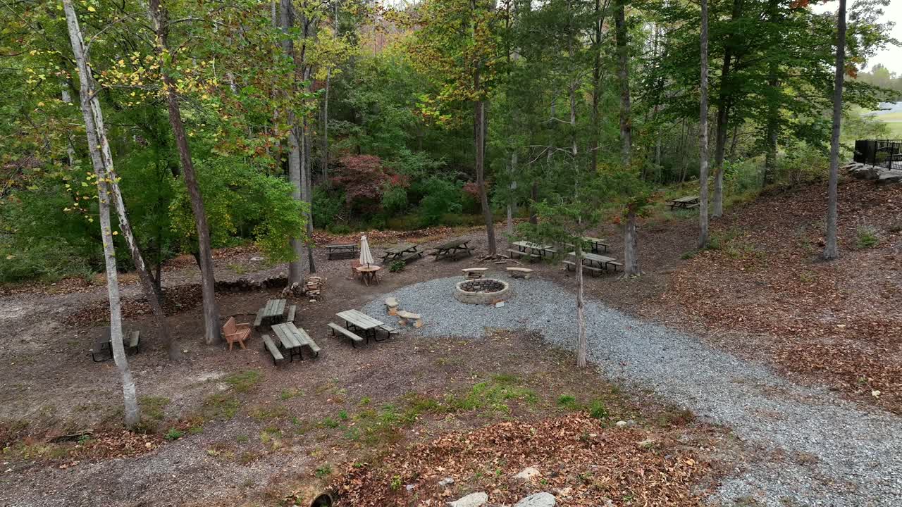 Aerial view of fireplace for barbecue on camping ground in rural woodland of America. Autumn season. Empty area