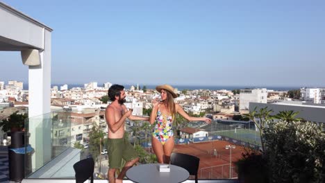 Romantic-Couple-Toasting-and-Flirting-on-the-Hotel-Balcony-in-Larnaca,-Cyprus