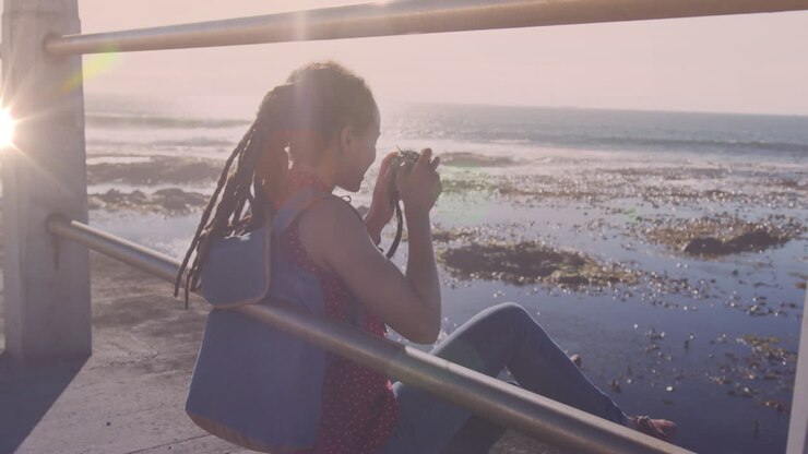 Animation of light spots over biracial woman taking photo with camera on promenade