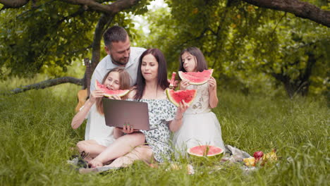 family picnic in the park with watermelon