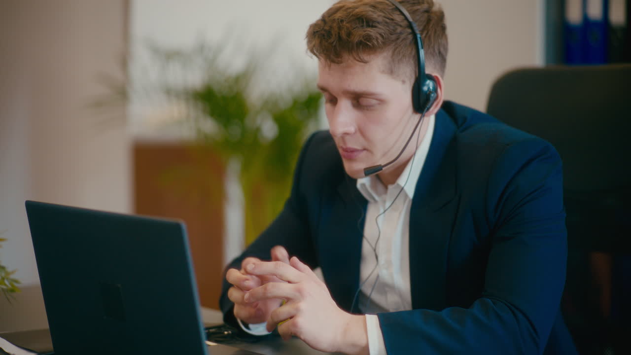 Businessman discussing on video call at workplace.