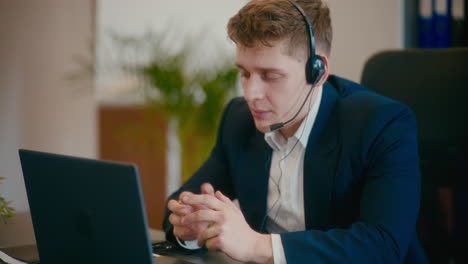 Businessman-discussing-on-video-call-at-workplace.