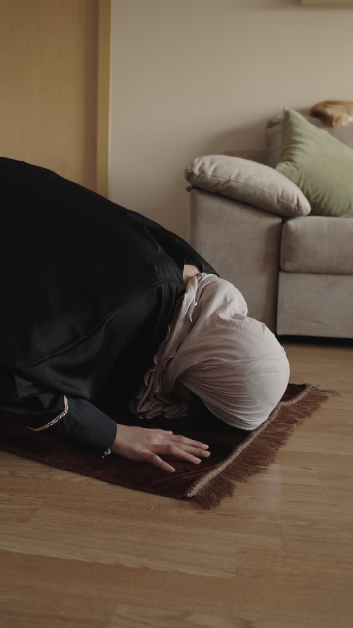 Muslim woman praying indoors