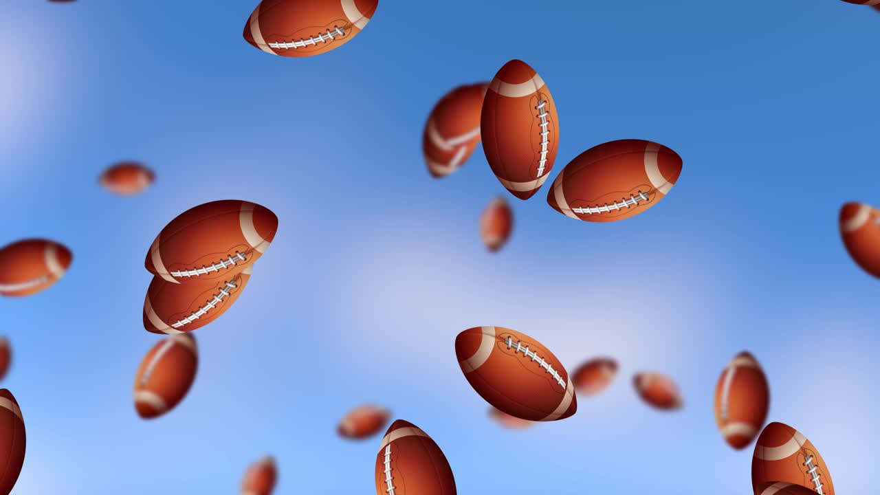 Footballs falling against a clear blue sky