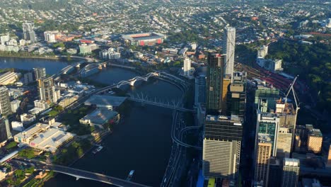 aerial tilt-up timelapse of brisbane city cbd with traffic on riverside expressway during early morning, australia