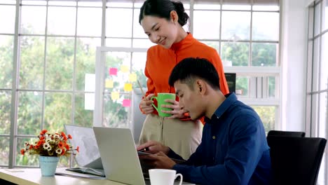 two business people talk project strategy at office