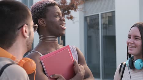 african transgender person talking distracted with friends outdoors