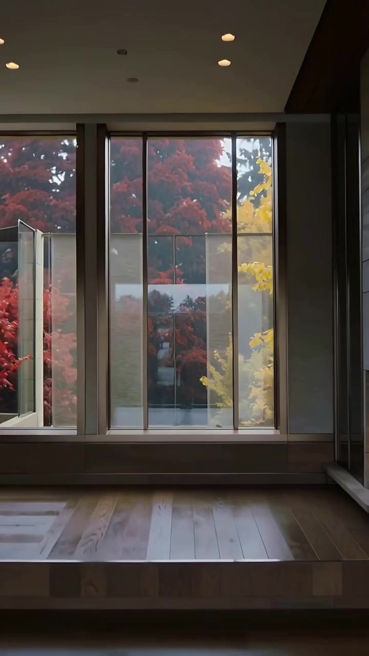 Vertical video: Zooming out camera showing reflection standing at glass balcony revealing left pane