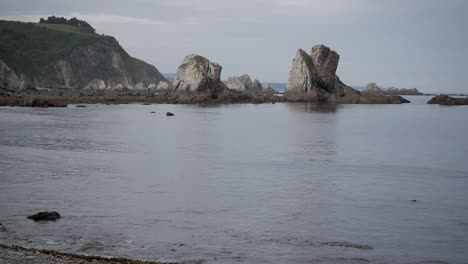 rocky coast at low tide, silence beach, asturias, with calm sea and soft daylight