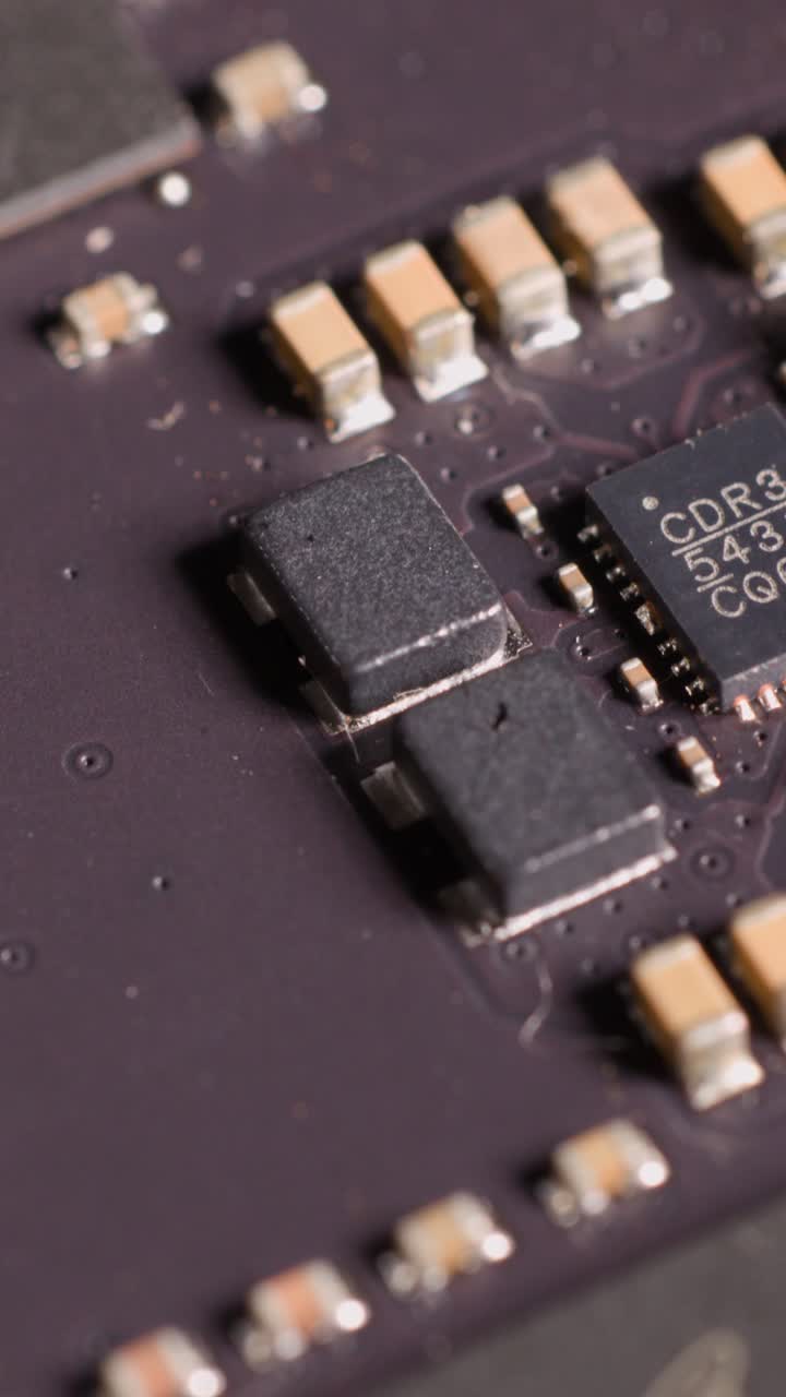 Extreme close-up panning across a computer memory module with detailed electronic components and microchips