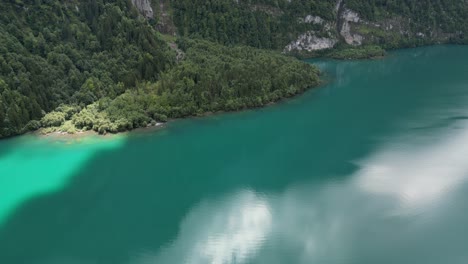 Klontalersee-lake-reflects-clouds-in-its-mirror-like-crystal-clear-water