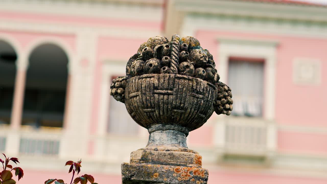 Close up of a decorative stone pillar in the courtyard of Villa Ephrussi de Rothschild with a blurred view on the background