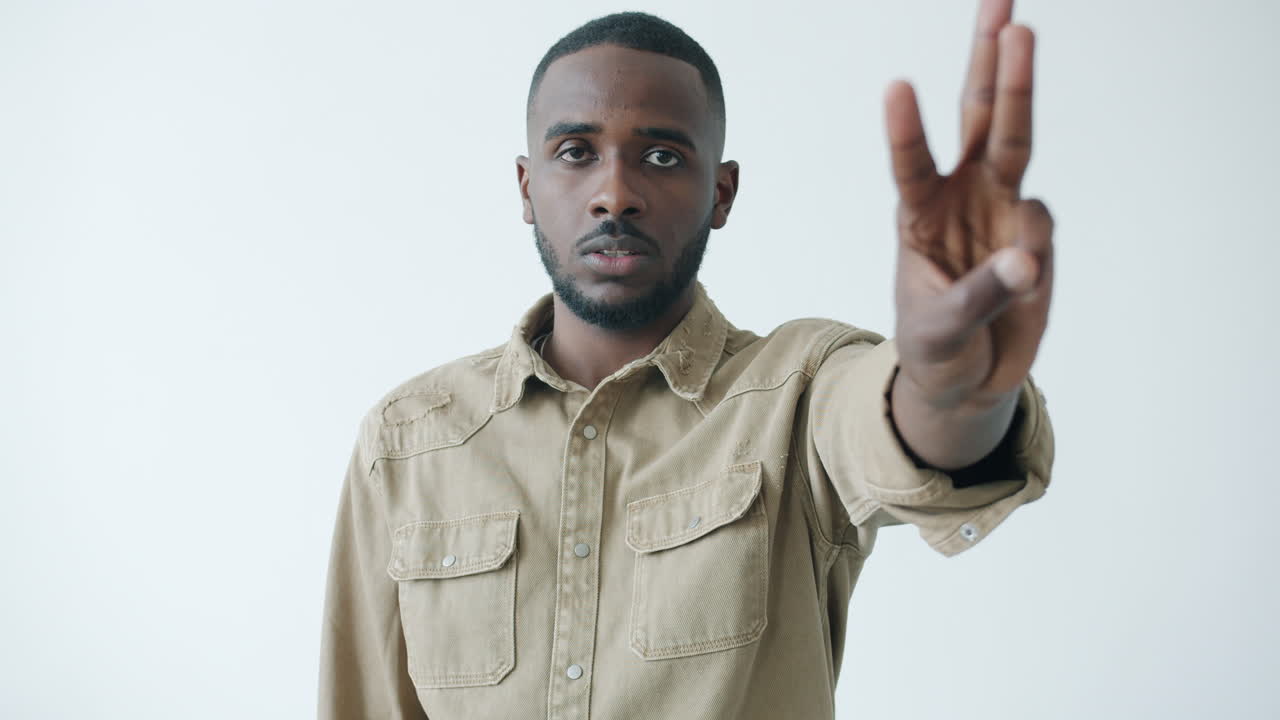 Man making a three finger gesture