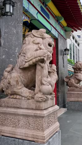 a walk past ornate temple guardians and walls.