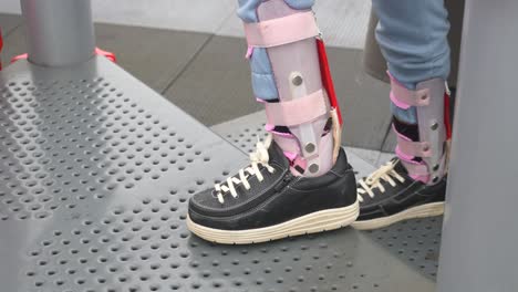 persona con un soporte de tobillo subiendo las escaleras