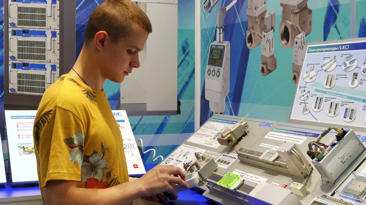 Teenager learning about electronics and automation at a technical exhibition