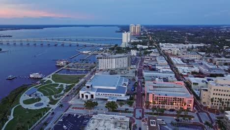 aerial flyover fort myers city with hotel and port during sunset time - caloosahatchee bridge and edison bridge in background