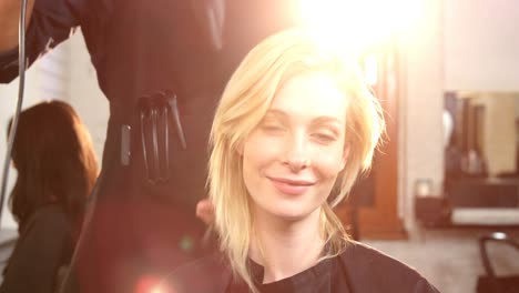 Woman-getting-her-hair-dried-with-hair-dryer