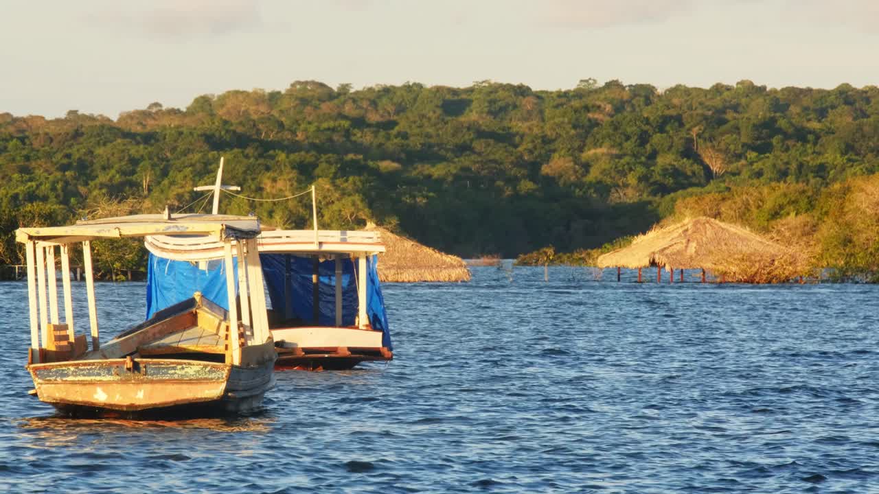 Boats moored in the waters near the city of Santar&eacute;m at sunset , State of Par&aacute;, Brazil