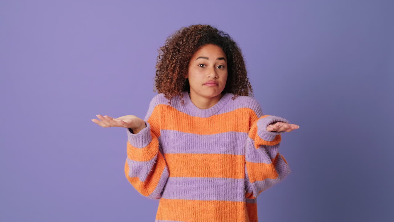 Pensive Young Woman Contemplating and Shrugging with Uncertainty