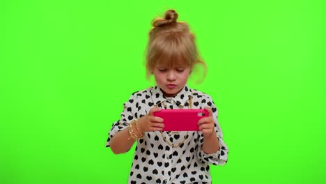 Worried-funny-addicted-child-girl-enthusiastically-playing-drive-racing-video-games-on-mobile-phone