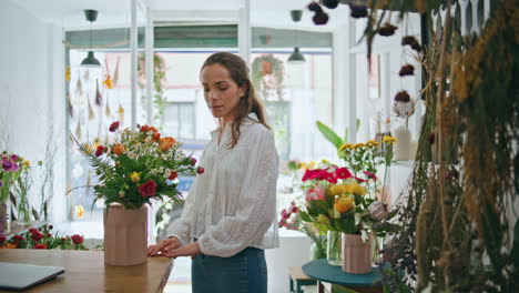 flower store retailer work make bouquet in beautiful spring plant shop business.