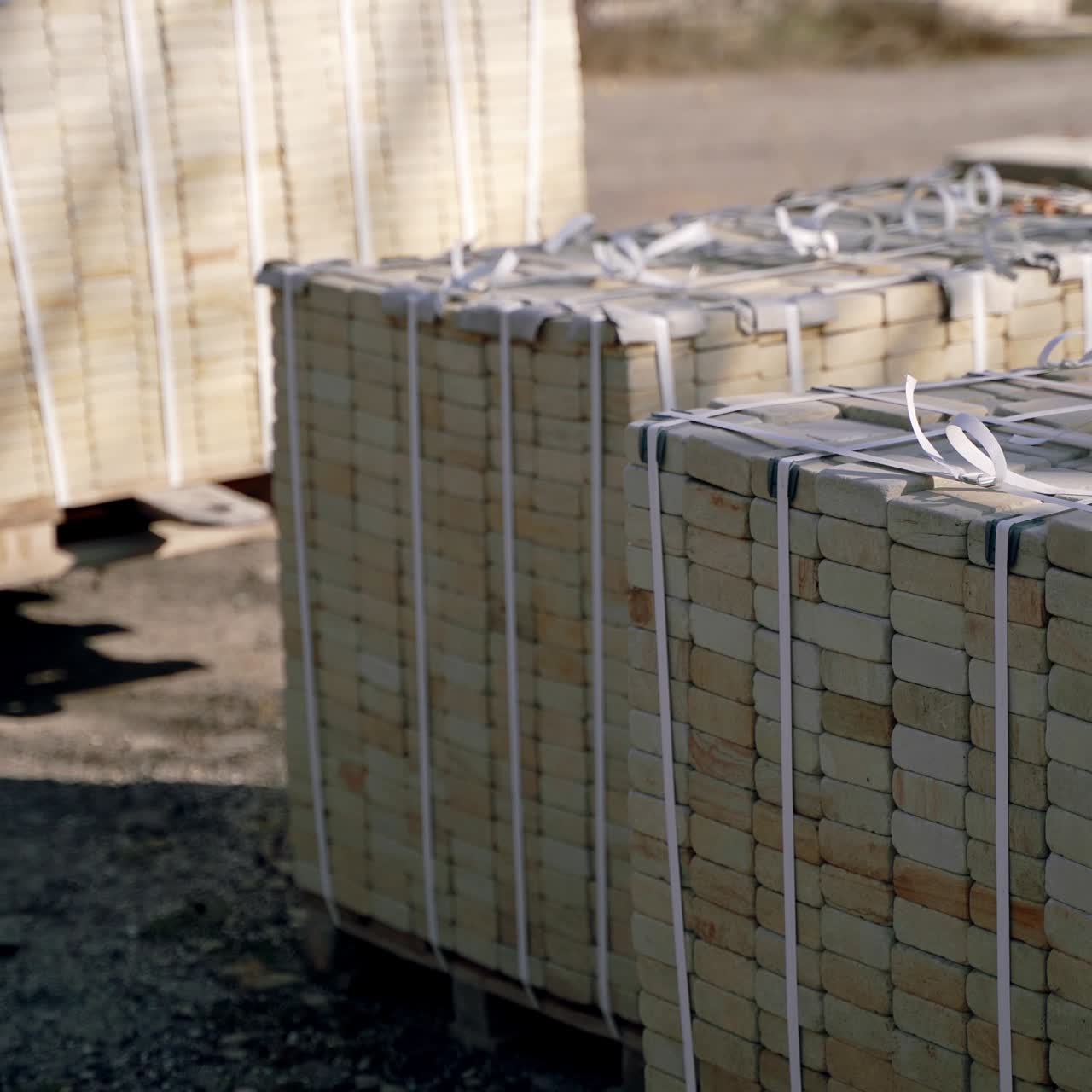 warehouse automatic truck is transporting pallets with bricks and folding its in one place on the territory of factory