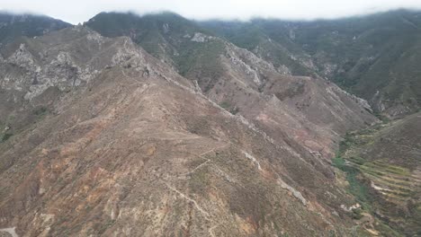 mountains and hiking trails under a layer of clouds in tenerife