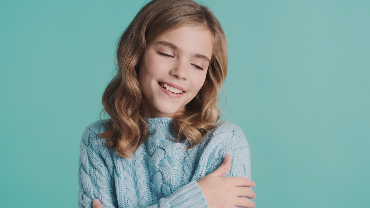 Happy teenage Caucasian girl in front of the camera.