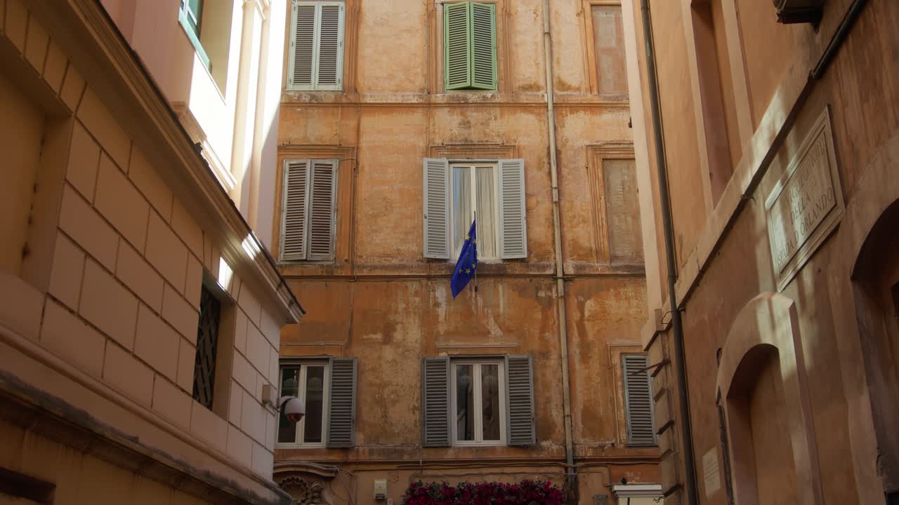 Quiet narrow alley in Rome with warm sunlight and rustic building walls