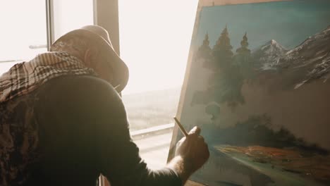 senior artist painting a landscape