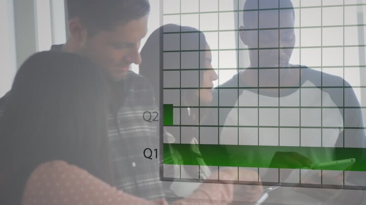 Animation of financial graphs and data over diverse coworkers working on tablet in office