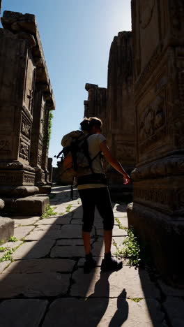 woman exploring ancient temple ruins