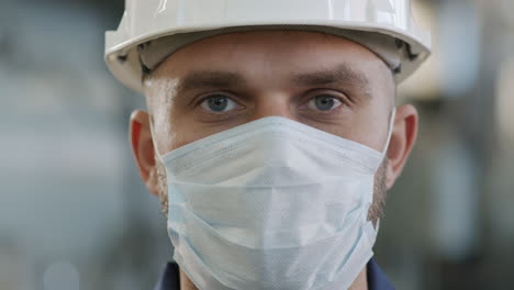 close up of male factory worker in face mask