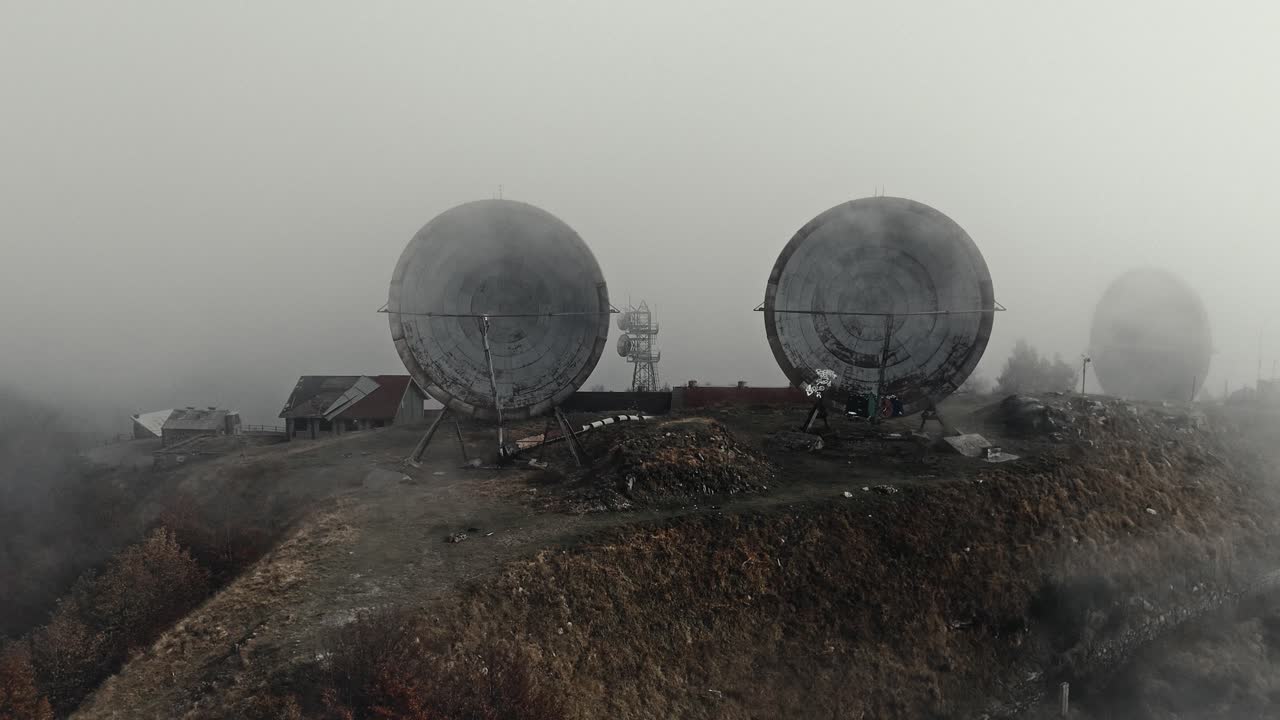 Abandoned Radar Domes on a Desolate Hilltop in Thick Fog