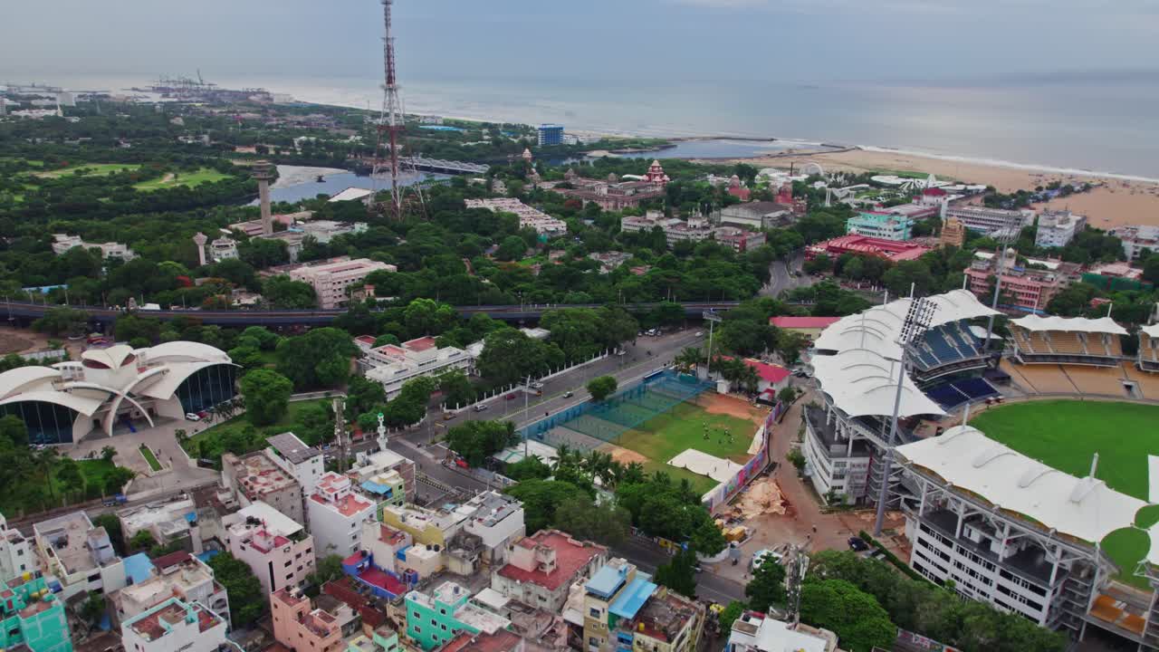 residential buildings through marina beach view with Chepauk Stadium and state guest house at Anna Salai, Triplicane, Chennai, Tamil Nadu, india. day time, push in, drone shot, 4k.