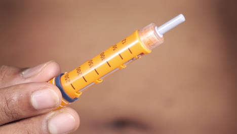 person holding an insulin pen