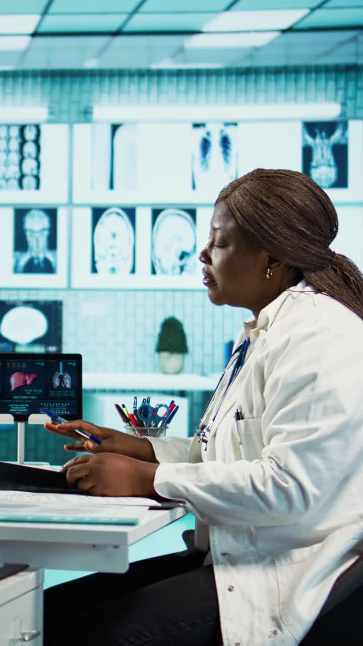 African American Doctor Working on Medical Reports in Modern Clinic