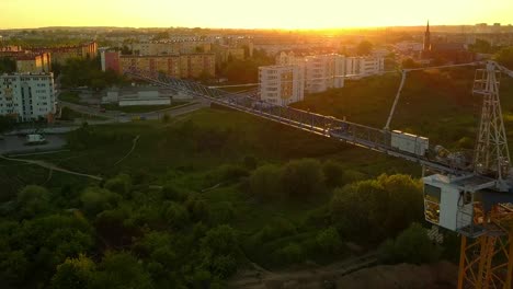 aerial of construction site and cranes at sunset